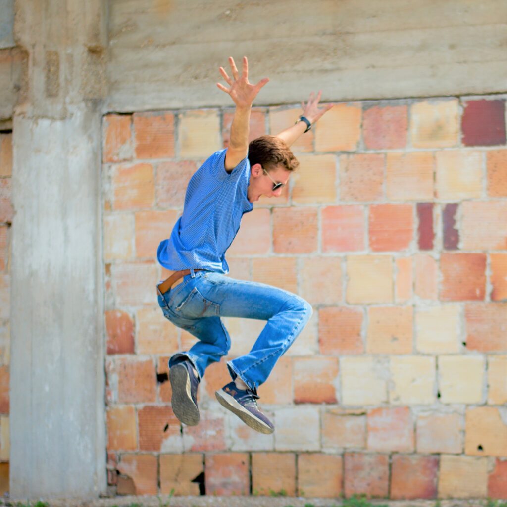 Man Jumping with arms stretched out.